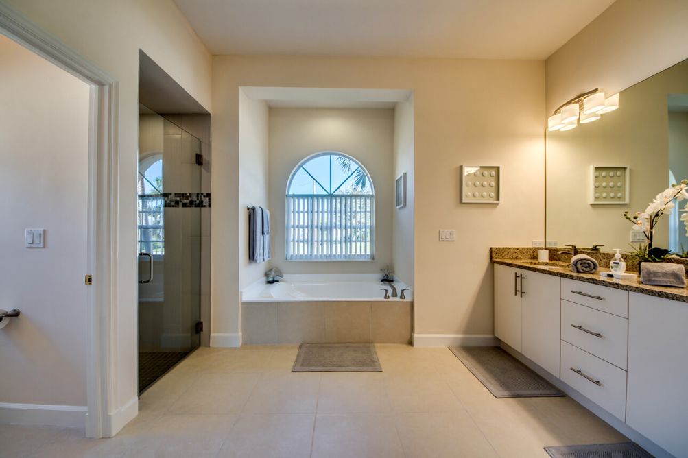 Hauptbadezimmer mit Badewanne und begehbarer Dusche in der Villa Blue Pearl in Cape Coral, Florida